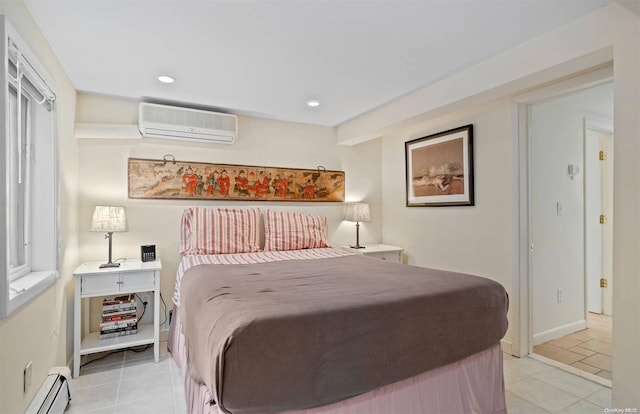 bedroom featuring a wall mounted air conditioner, a baseboard heating unit, and light tile patterned flooring