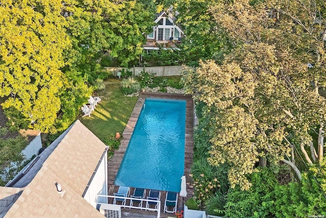 view of pool featuring a lawn