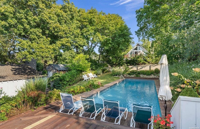 view of swimming pool with a wooden deck