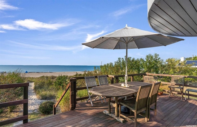 wooden terrace featuring a view of the beach and a water view