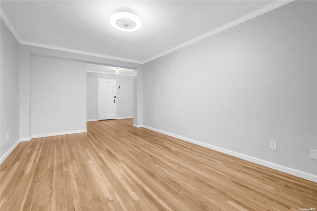 empty room featuring ornamental molding and light wood-type flooring