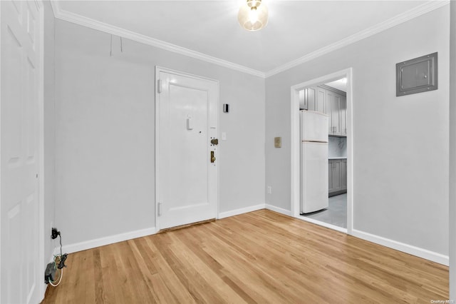 empty room with ornamental molding and hardwood / wood-style flooring