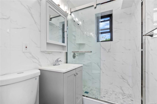 bathroom featuring vanity, decorative backsplash, toilet, tile walls, and a shower with shower door