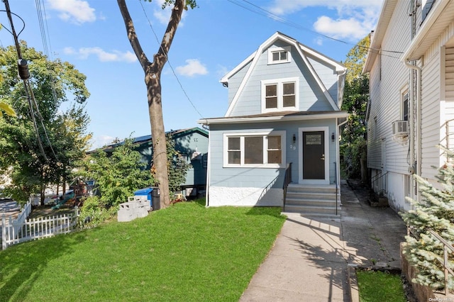 view of front of home featuring cooling unit and a front yard