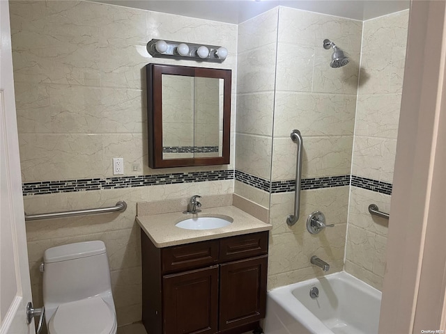 full bathroom with vanity, tiled shower / bath combo, toilet, and tile walls