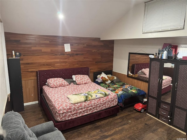 bedroom featuring dark wood-type flooring and wooden walls