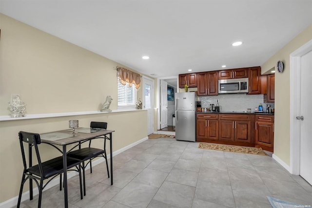 160-28 87th St, Howard Beach, NY 11414 - kitchen with appliances with stainless steel finishes, dark countertops, decorative backsplash, and recessed lighting
