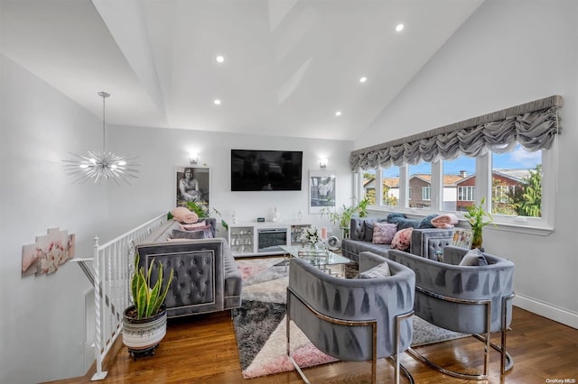 living room featuring dark hardwood / wood-style flooring, high vaulted ceiling, and an inviting chandelier