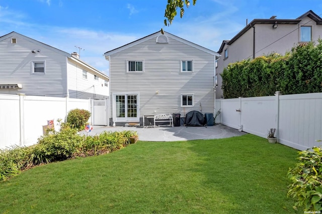 rear view of house featuring a patio and a lawn