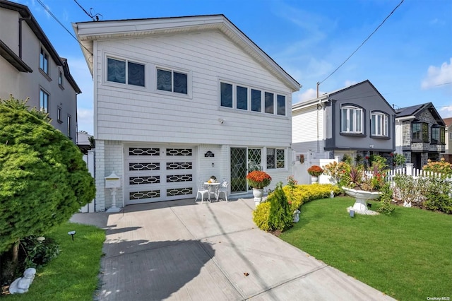 view of front of home with a front yard and a garage