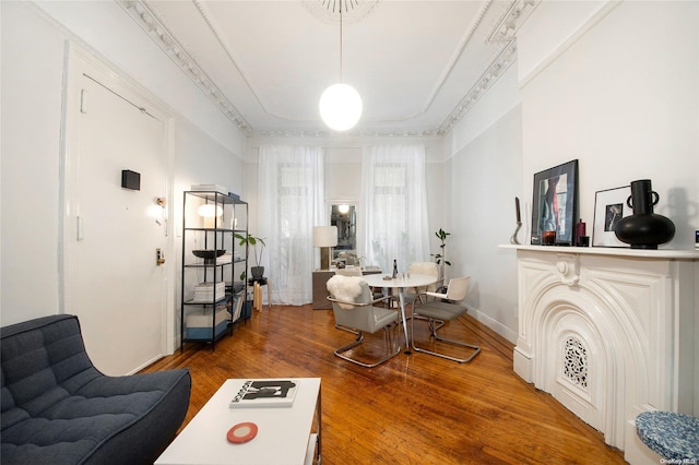 dining area featuring hardwood / wood-style flooring and crown molding