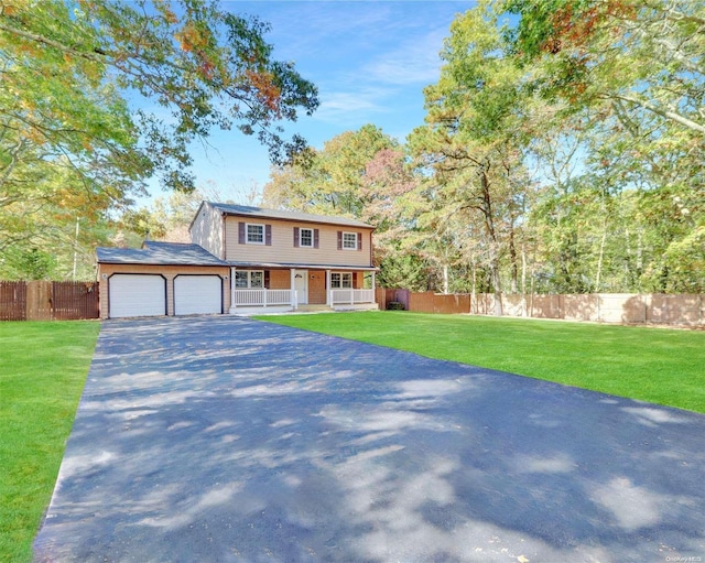 view of front of home with a porch, a garage, and a front yard