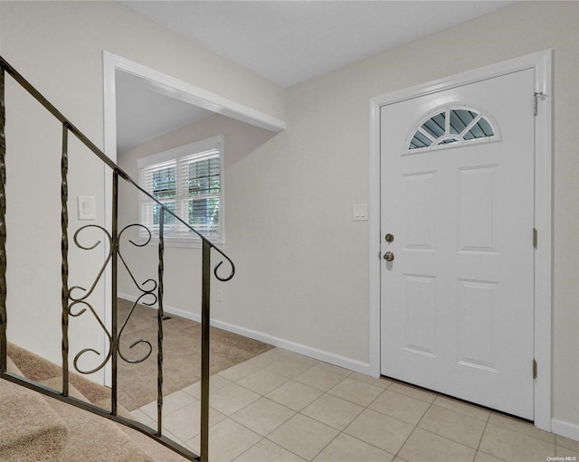 foyer entrance with light tile patterned floors