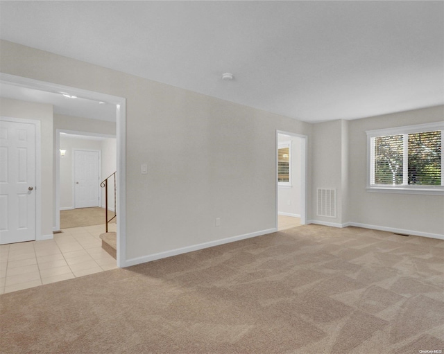 spare room with light colored carpet