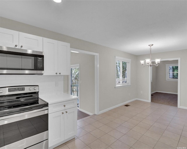 kitchen with white cabinetry, a wealth of natural light, and stainless steel appliances