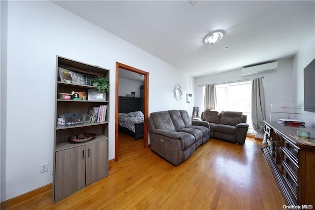 living room with light wood-type flooring and a wall mounted AC