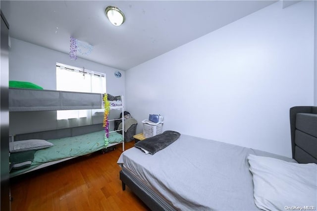 bedroom with dark hardwood / wood-style flooring