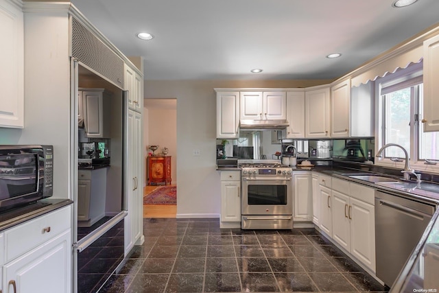 kitchen with stainless steel appliances, white cabinetry, and sink