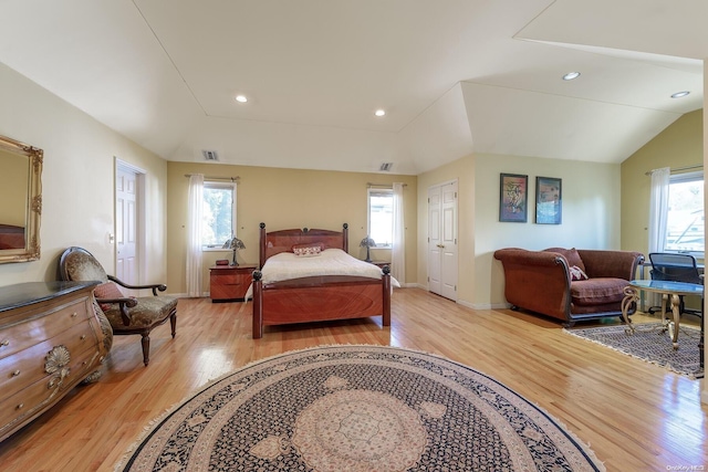 bedroom featuring light wood-type flooring and lofted ceiling