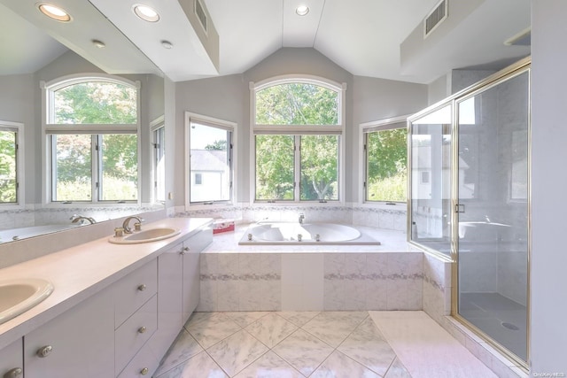 bathroom featuring tile patterned flooring, vanity, vaulted ceiling, and separate shower and tub