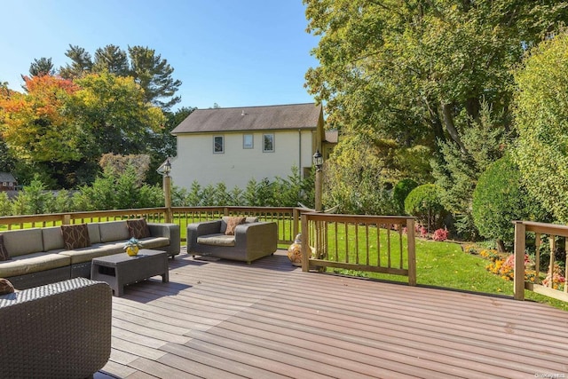 wooden terrace with a lawn and an outdoor living space