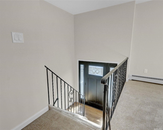 interior space with carpet and a baseboard heating unit