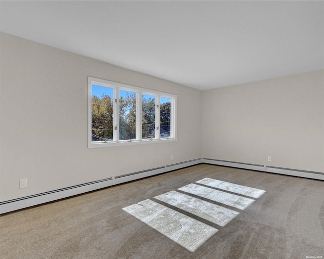 spare room featuring light colored carpet and baseboard heating