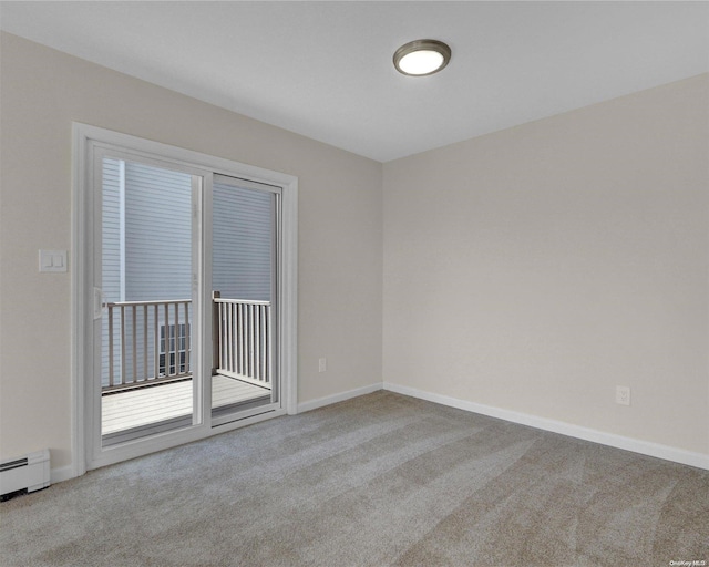 carpeted empty room with baseboard heating