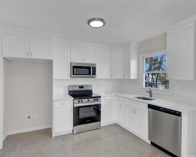 kitchen with white cabinetry, sink, stainless steel appliances, tasteful backsplash, and light tile patterned flooring