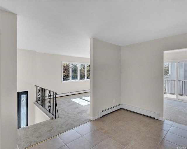 carpeted empty room with baseboard heating