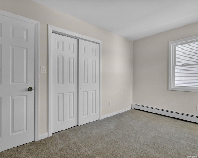 unfurnished bedroom with light carpet and a baseboard radiator