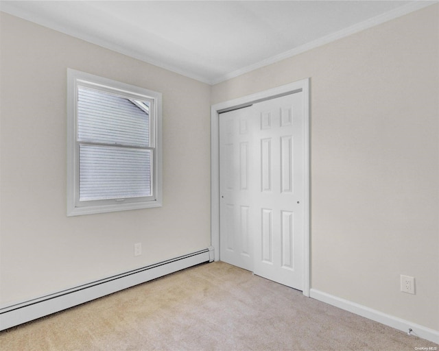 unfurnished bedroom featuring light carpet, ornamental molding, a closet, and a baseboard heating unit