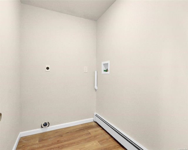 clothes washing area with electric dryer hookup, washer hookup, light hardwood / wood-style floors, and a baseboard heating unit