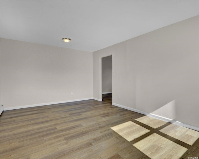 unfurnished room with hardwood / wood-style flooring