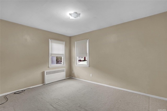 unfurnished room with carpet floors and radiator