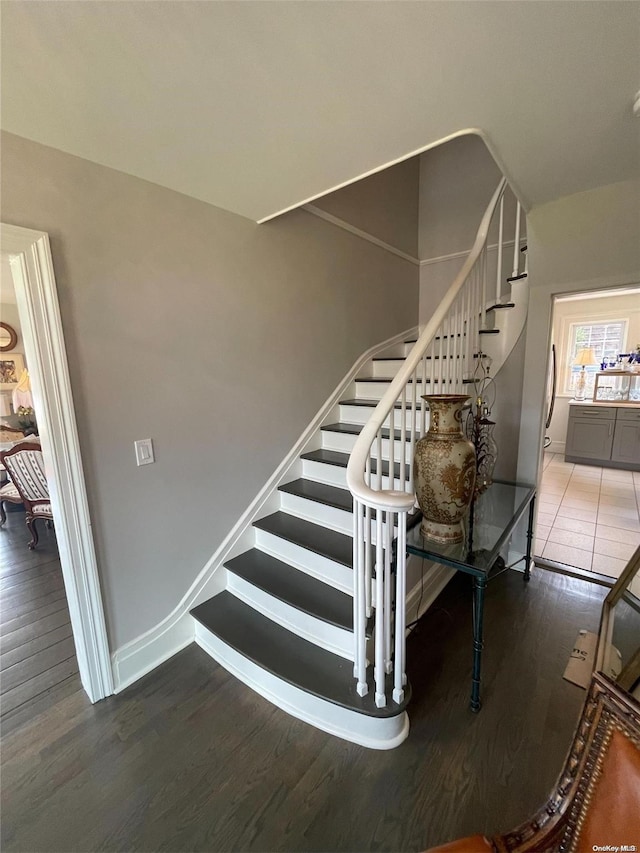 stairway with hardwood / wood-style flooring