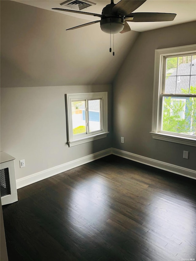 bonus room with lofted ceiling, plenty of natural light, and dark hardwood / wood-style floors