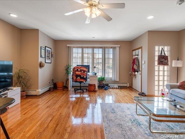 living room featuring a wealth of natural light, ceiling fan, and light wood-type flooring