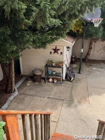 view of patio with a storage shed