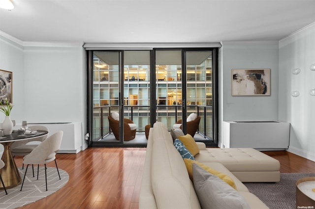 living room with hardwood / wood-style floors and ornamental molding