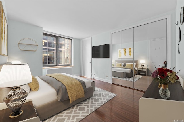 bedroom featuring dark hardwood / wood-style floors and a closet