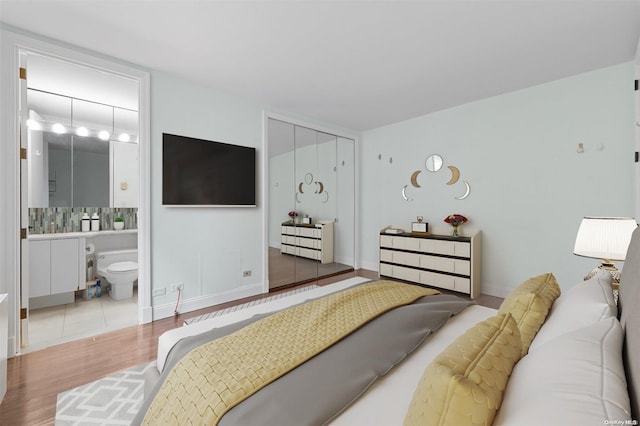 bedroom featuring a closet and light hardwood / wood-style flooring