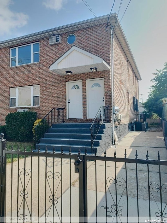 view of front of home featuring a wall mounted air conditioner