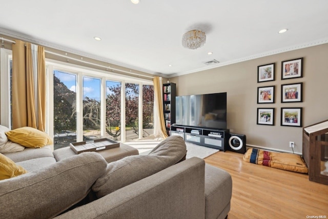 living room with hardwood / wood-style flooring and ornamental molding