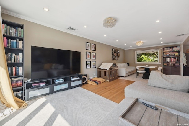 living room with hardwood / wood-style flooring and ornamental molding