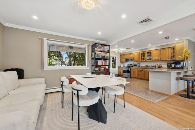 dining area with light hardwood / wood-style floors, an inviting chandelier, baseboard heating, and crown molding