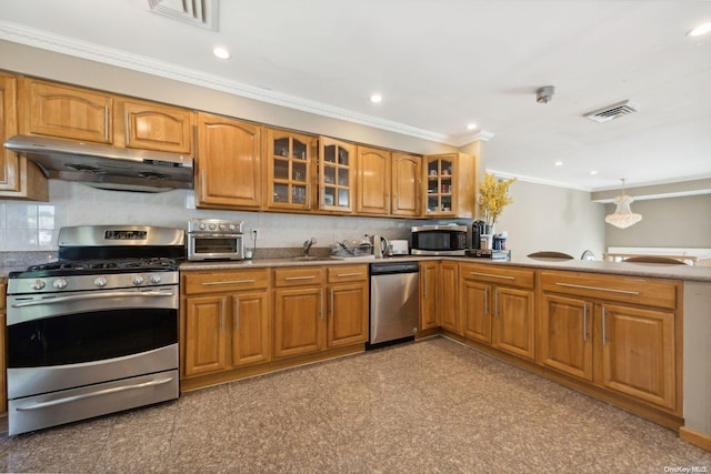 kitchen with appliances with stainless steel finishes, tasteful backsplash, ornamental molding, and sink