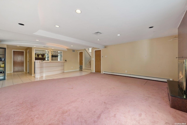 unfurnished living room featuring baseboard heating and light carpet