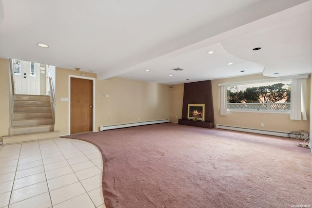 unfurnished living room with beamed ceiling, light tile patterned floors, a fireplace, and a baseboard heating unit