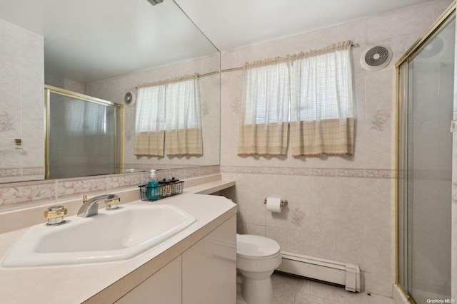 bathroom featuring plenty of natural light, tile patterned flooring, tile walls, and a baseboard heating unit